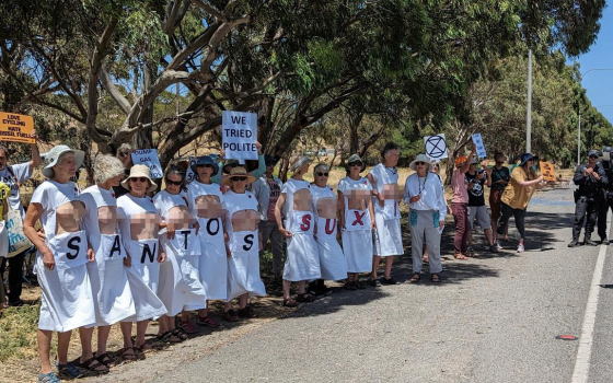 Police arrest three older rebels after they expose breasts and bums to passing cyclists at the TDU